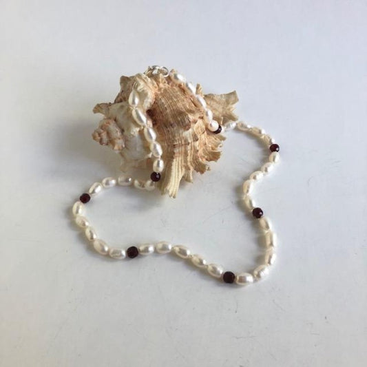 Hand-knotted 18" White pearl and Garnet Necklace shown on shell prop