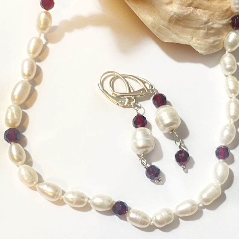 Alternative closeup partial view of garnet hand-knotted pearl necklace with matching earrings in this bundled set
