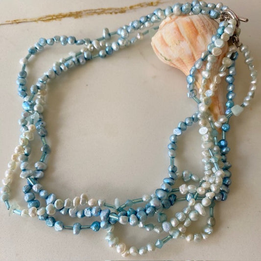 Beaded 15-inch blue and white freshwater pearl choker  on shell prop display