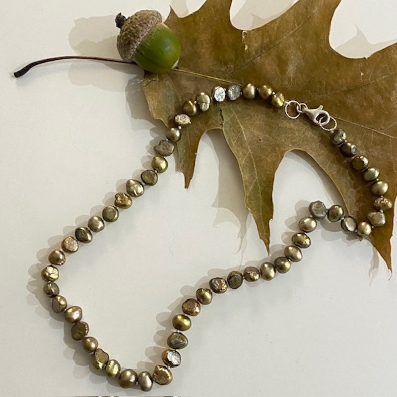 Hand-knotted 16-inch bronze freshwater pearl choker top view shown with fall acorn and oak leaf