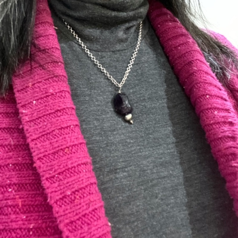 Closeup of the amethyst nugget pearl pendant necklace on model