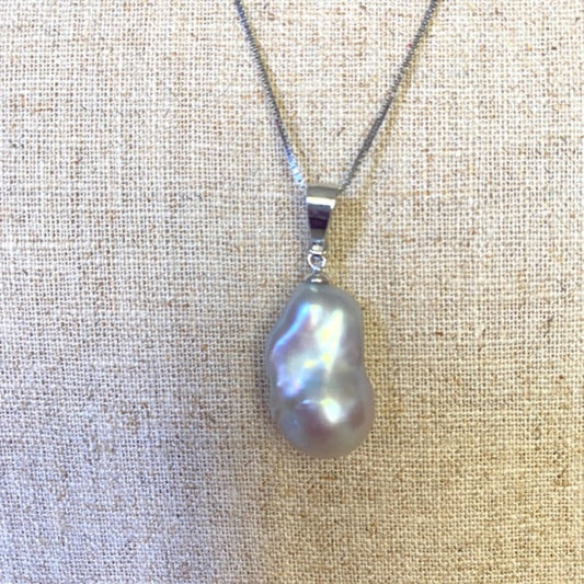 Closeup Pink Baroque Pearl Pendant on 18 inch delicate sterling chain shown on linen background