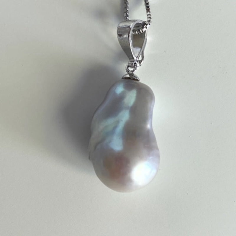 Closeup of the details of the organic pink baroque pearl sterling bail