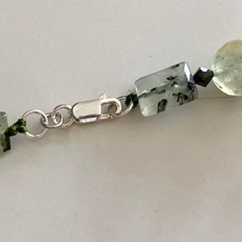 Closeup of the sturdy Sterling Lobster clasp and hand-knotted adjacent Prehnite beads