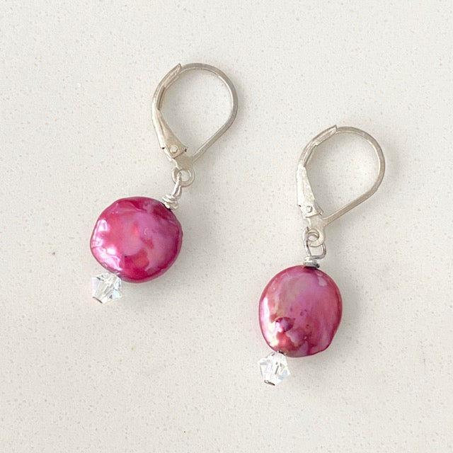 Top flat view of the dyed cranberry coin pearl earrings with Austrian crystal accents on the sterling lever-back ear wires.