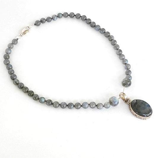 Another 3/4 view of the knotted grey Labradorite necklace with its kinetic motion 1-3/4  inch oval Labradorite pendant