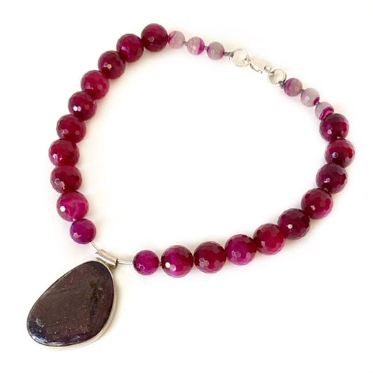 Bold magenta Agate pale striped pink agate Woman in Motion 18-inch kinetic pendant necklace three-quarter view