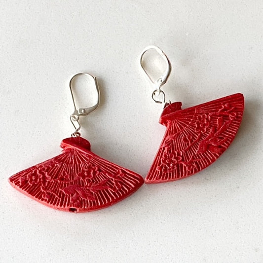 Top view red Cinnabar-looking scrolled fan shaped earrings on stainless steel lever-backs