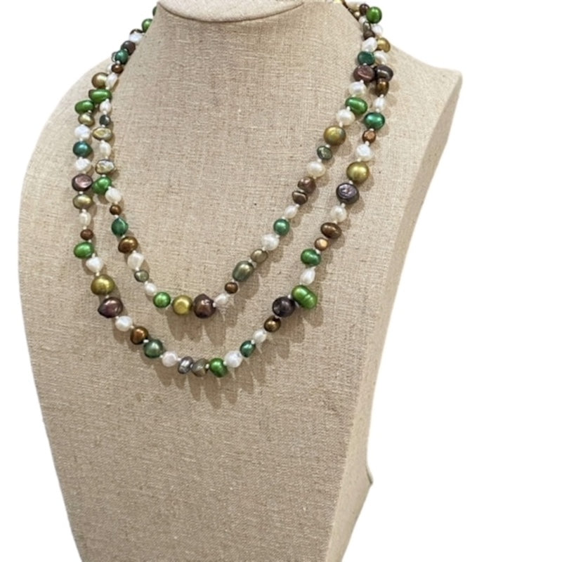 3/4 View of the double strand Gardenia  multi-coloured white green gold brown pearl necklace on a linen jewelry display stand