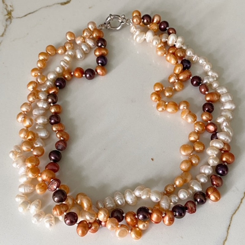 Top view Triple Strand Orange Brown White Knotted Pearl Necklace