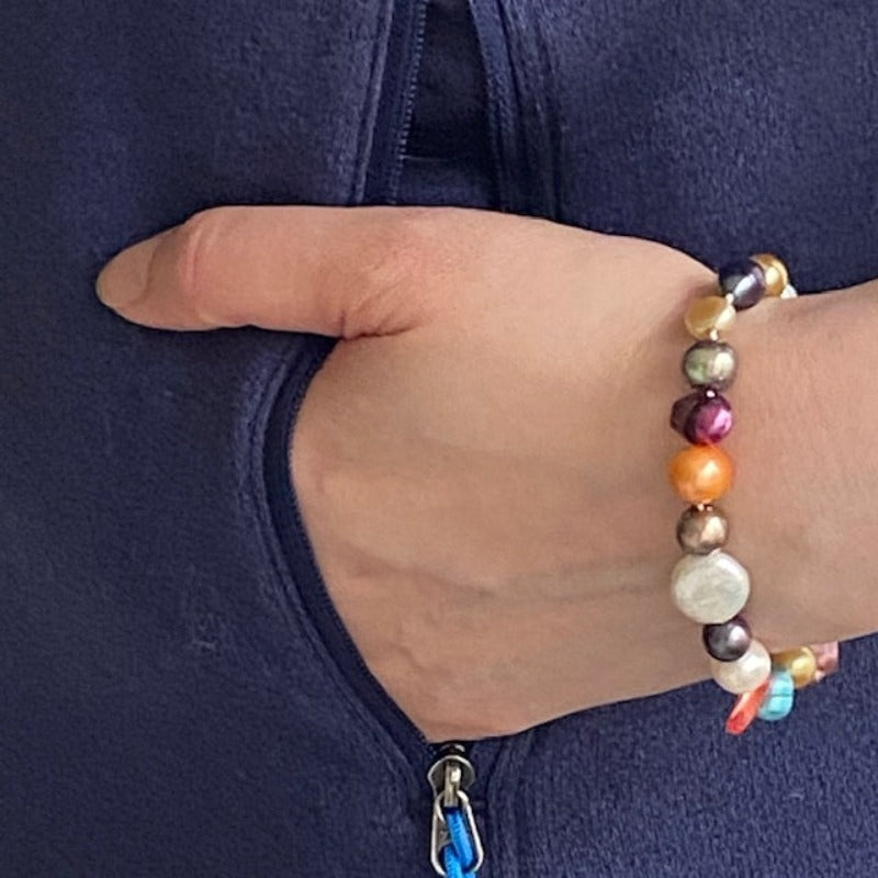 7-inch hand-knotted dyed multi-coloured pearl bracelet worn  on model's wrist