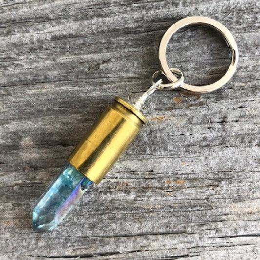 Aqua Blue Crystal Bullet Keychain shown on wood