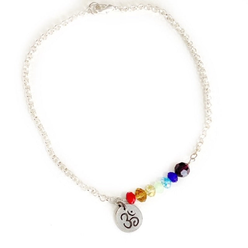 Asymmetrical Yoga Chakra 16-inch necklace with facetted coloured crystals and Ohm metal charm silver-plated chain