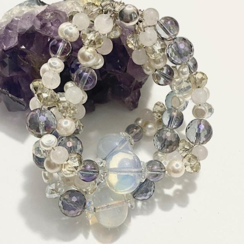 Beaded five strand opalite rose quartz pearl with crystals twisted bracelet on amethyst display prop