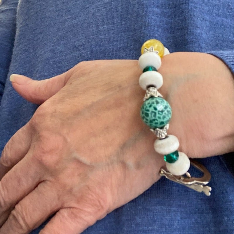 Beaded green yellow white agate bracelet shown on model's wrist