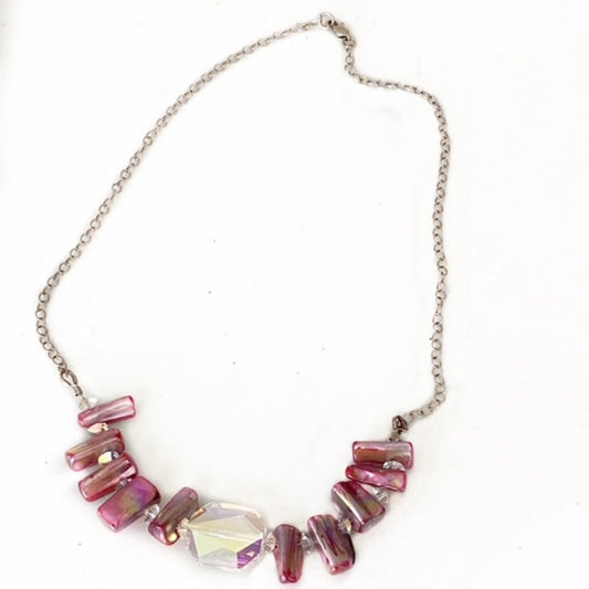 Beaded magenta pink mother-of-pearl 17 inch necklace with large faceted Austrian rectangular centre crystal on darkened Sterling silver chain and clasp top view