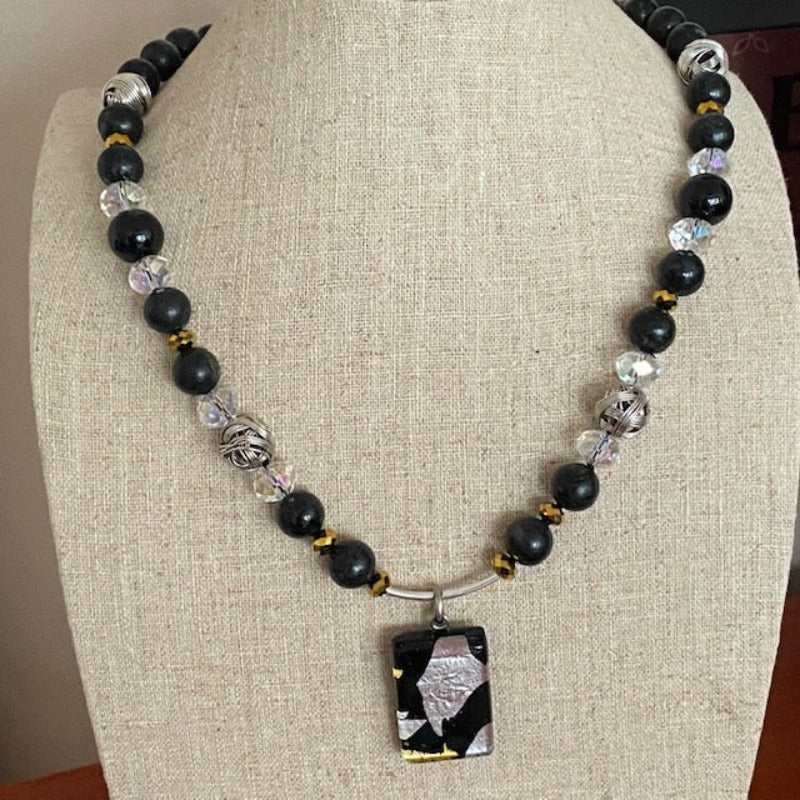 Black-silver-gold Dichroic glass 18-inch Kinetic Motion necklace shown on linen jewelry bust