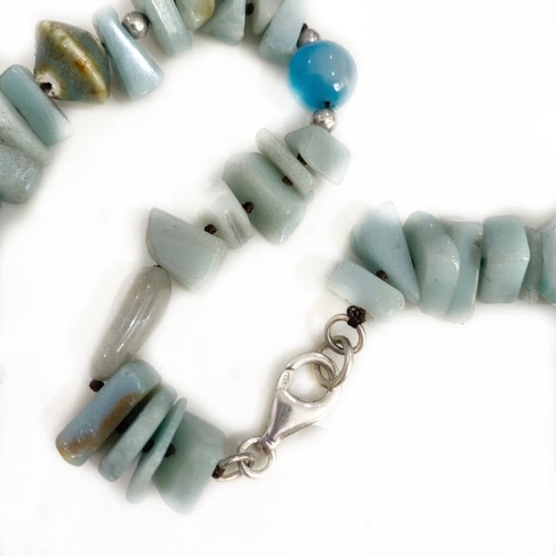 Closeup of the irregularly shaped Amazonite nuggets , a blue agate, porcelain bead and sterling silver lobster clasp