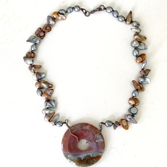 Brown and blue blister pearls hand-knotted 18-inch necklace with gunmetal wire-wrapped round brown-blue-green donut pendant and gunmetal clasp top view