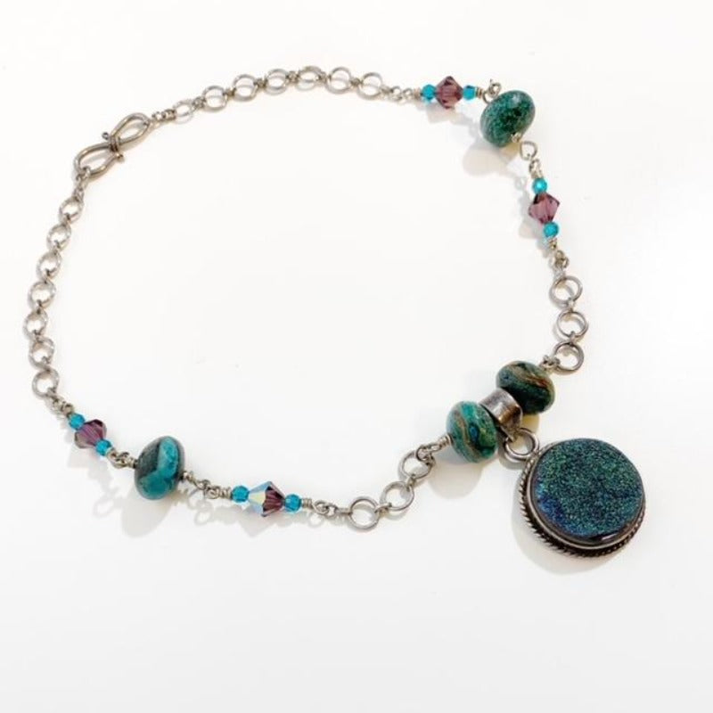 Wire-wrapped Chrysocolla bead Sterling silver chain link necklace with turquoise and purple Austrian crystal segments and round iridescent Drusy pendant