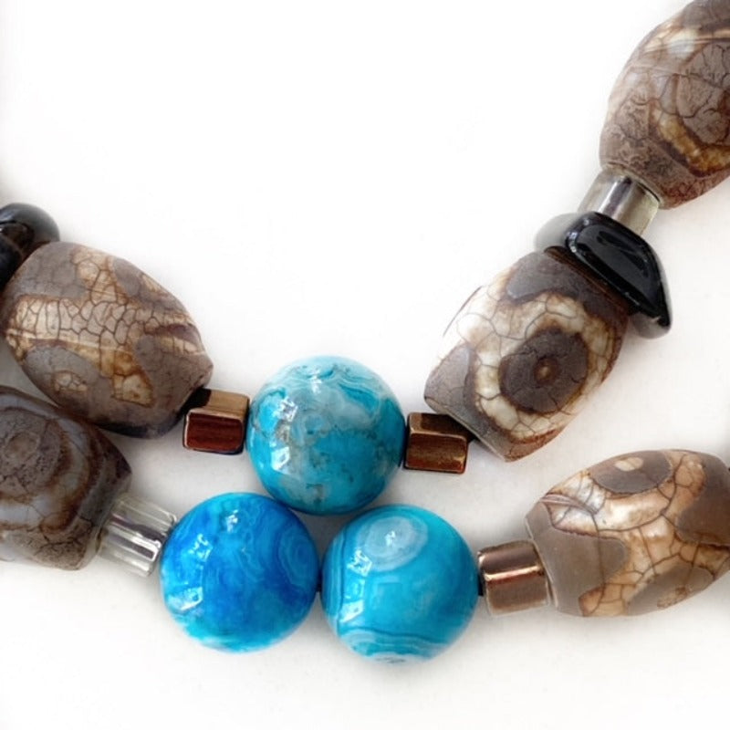 Closeup of the three bright polished blue agates centre of necklace representing the robin eggs