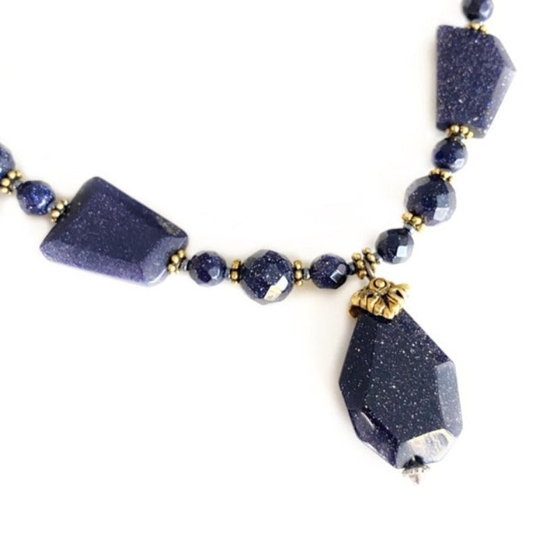 Closeup of the blue goldstone pendant and centre blue goldstone faceted beads with gold spacer accents
