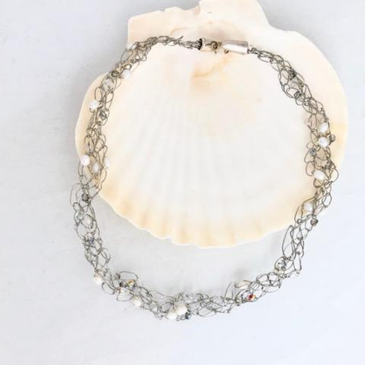 One-of-a-kind Crochet Wire Bridal Pearl Necklace shown on a shell display