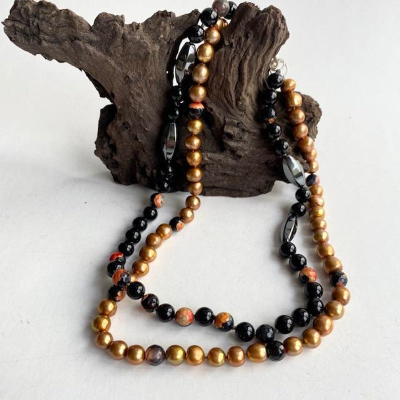 Double Strand Koi Hematite Gold Pearl Mottled Orange Black Agate Hand-knotted Adaptive Necklace shown on Driftwood prop
