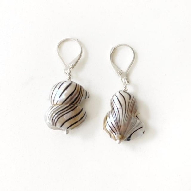 Freshwater baroque free-form white pearls with fine black vertical painted lines to look like zebra stripes. Sterling silver lever-back style. Top view
