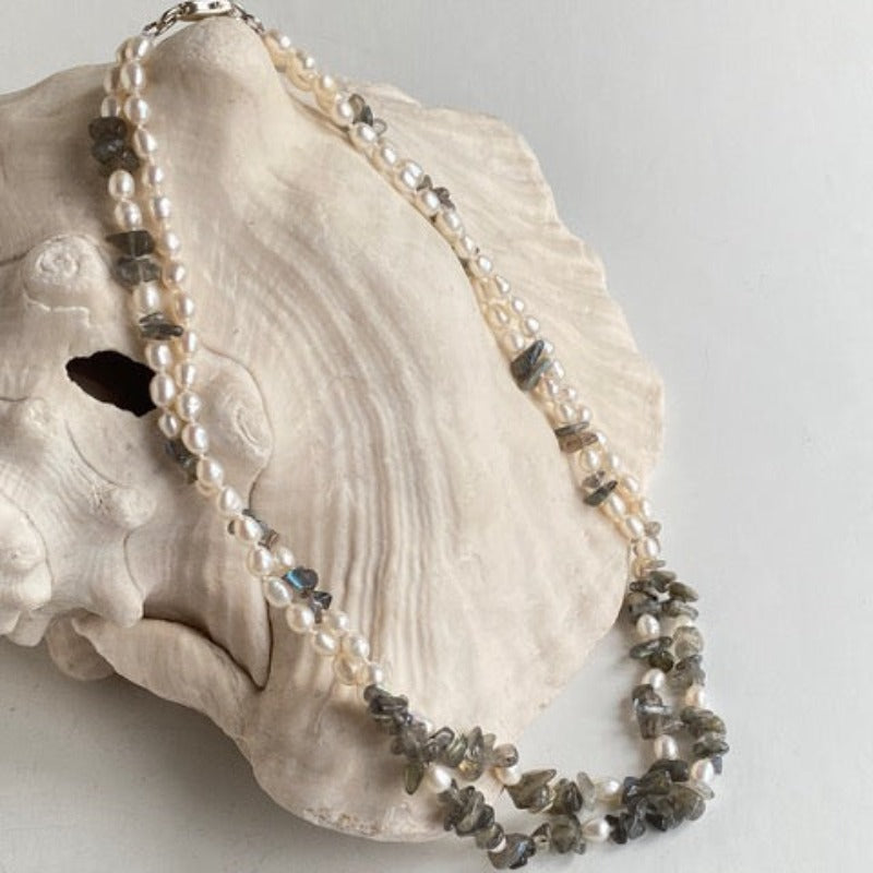 Full double strand knotted white pearl and  Labradorite chip 18-inch necklace draped on conch shell prop