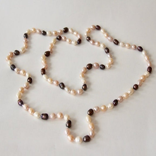 Long Peach Cream Black Pearl Necklace shown from a top view