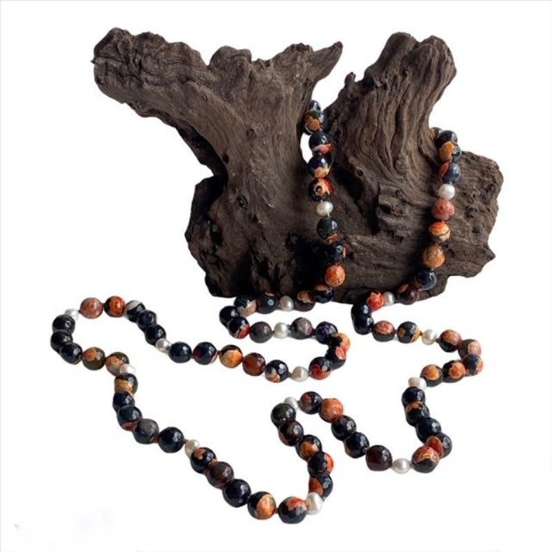 Koi Long Hand-knotted Single Strand Orange Agate White Pearl Necklace shown on Driftwood Display