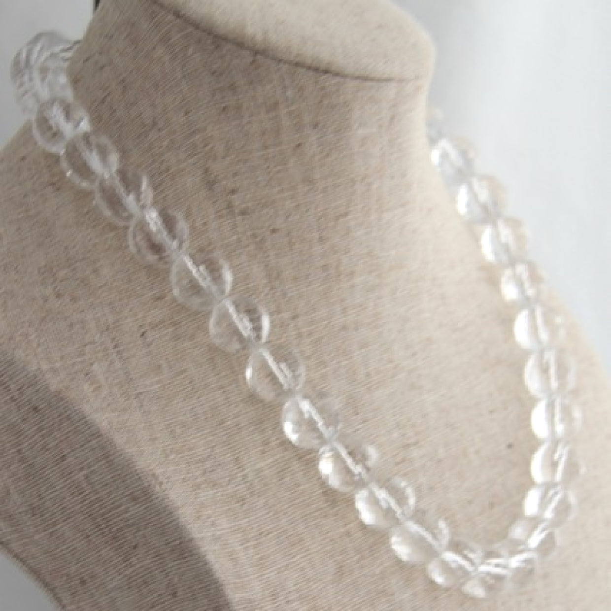 Left Side View Clear White Beaded Necklace on LInen Bust