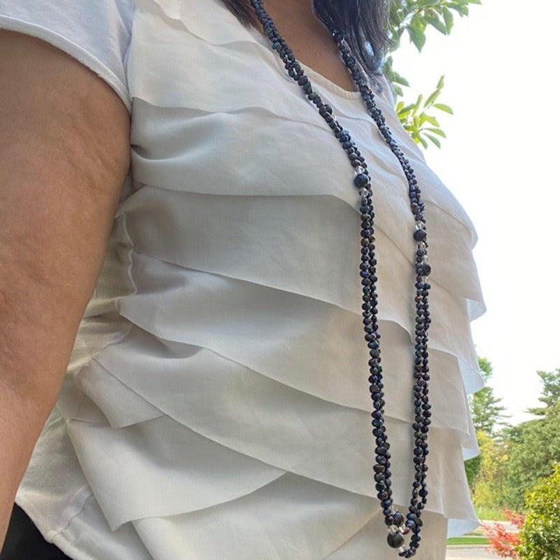 Long 47-inch inky black pearl and crystal necklace shown worn long  and loose doubled on model