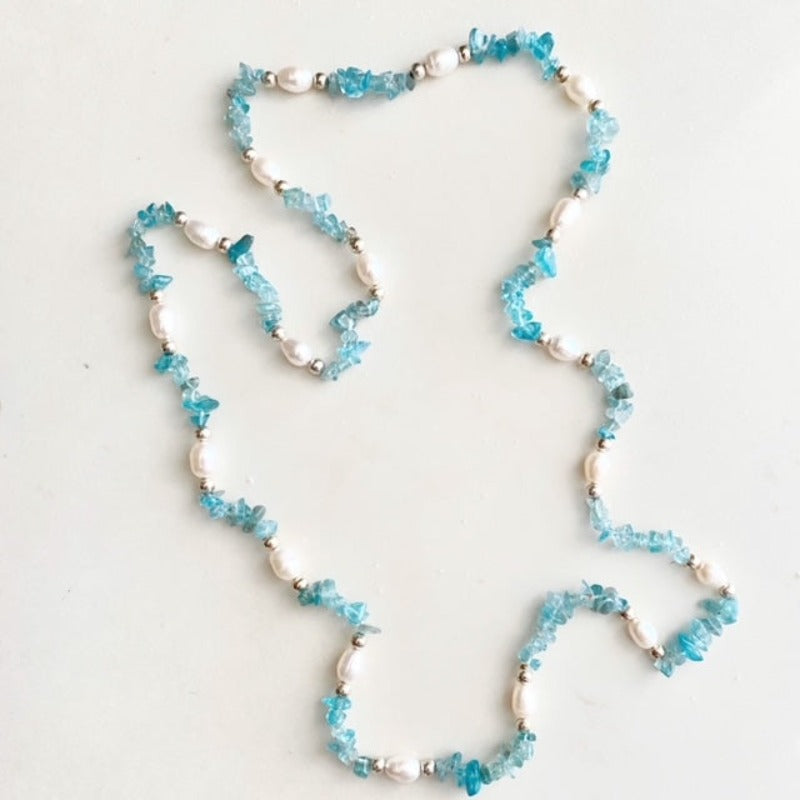 Long hand-knotted 33-inch aquamarine chip and white pearl necklace top view