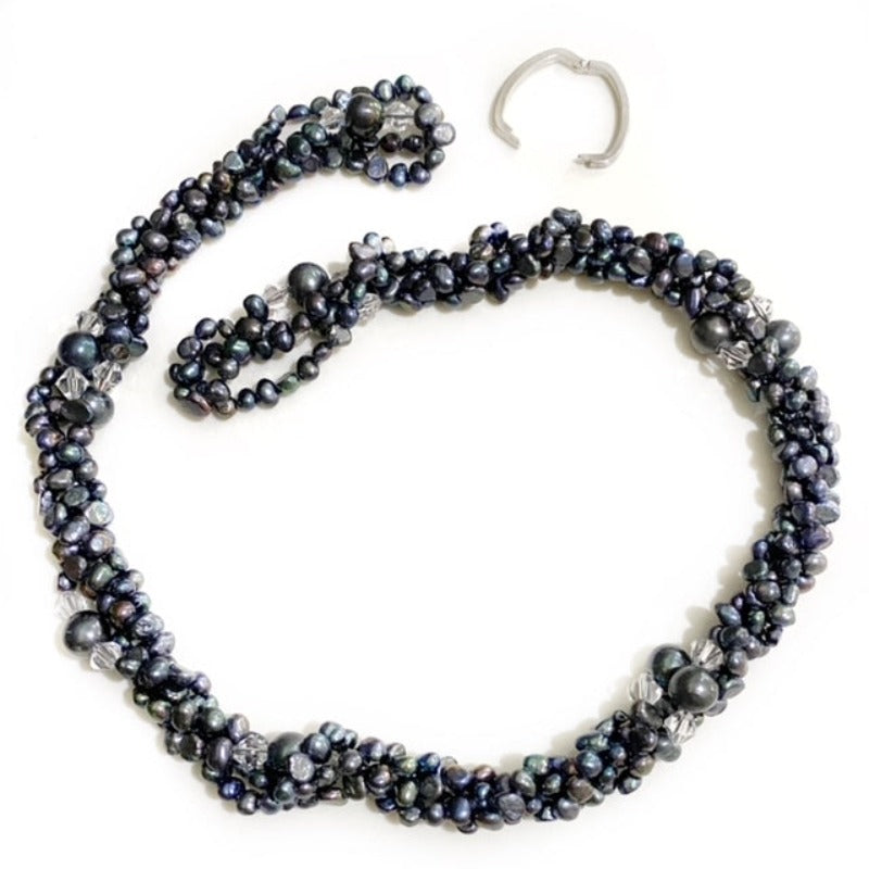 Long 47-inch inky black pearl and crystal accent necklace shown top view twisted into a choker-style with open link clasp