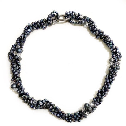 Long 47-inch knotted black pearl and crystal bead necklace shown twisted into a choker-style with attached silver tone metal link clasp