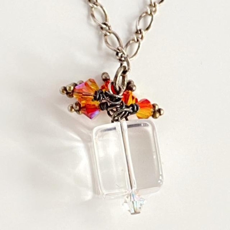 Clear Cube Pendant necklace with sparkling orange Austrian Crystals to look like a bow on top