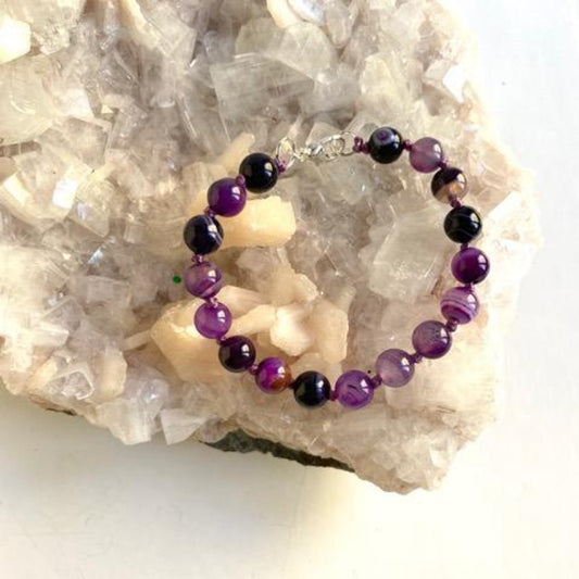 Purple Agate Hand-knotted 7 1/2" Bracelet shown on Crystal Display