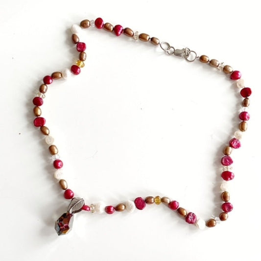 Red bronze and white freshwater pearl 19" necklace with facetted rainbow teardrop prism pendant top view