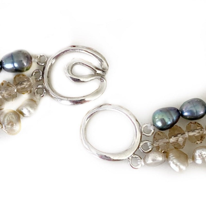 Closeup view of the silver-tone multi-strand  slip-together clasp