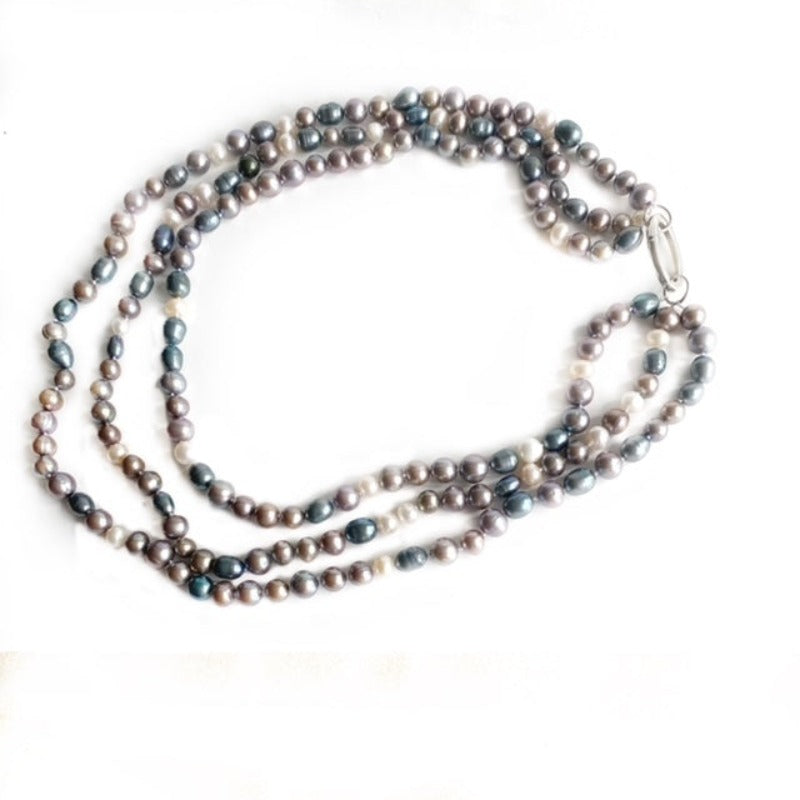 Alternate view of triple strand lavender blue and white pearl necklace with removable sterling oval link clasp top view