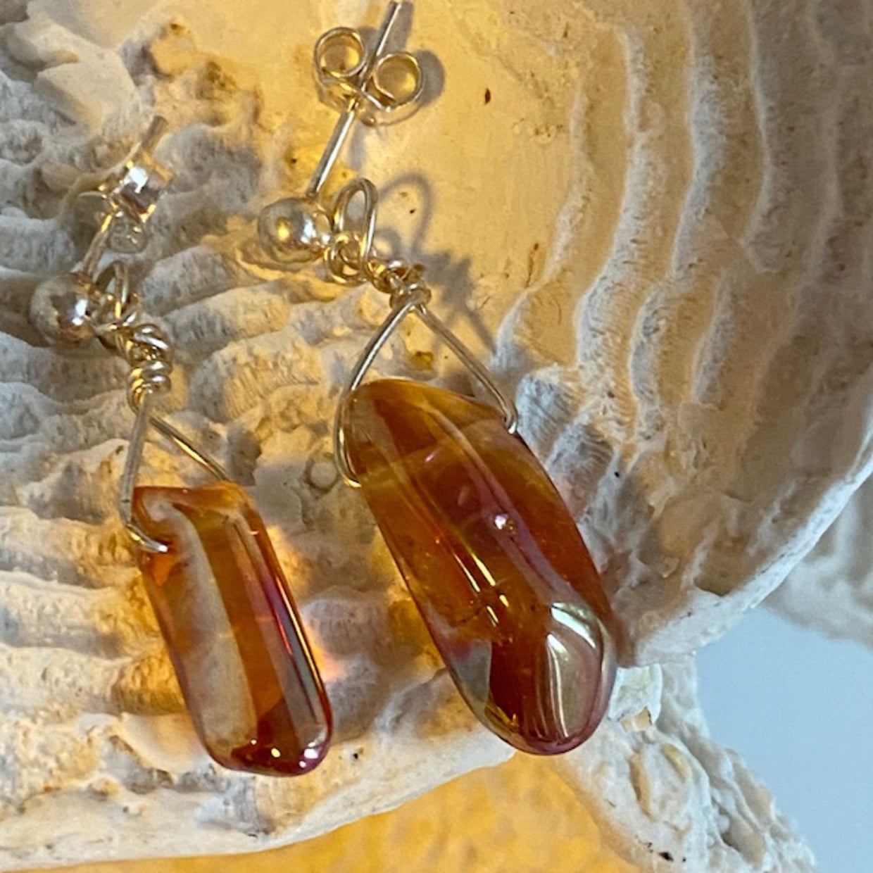 Shiny Gold Electroplated Quartz Stud Earrings on Prop Display