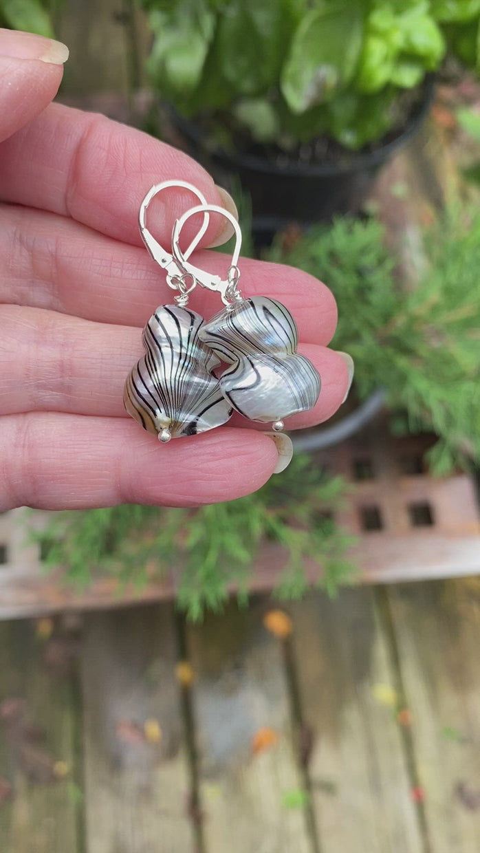 Video of the freshwater baroque pearl Zebra-like striped one and a half inch sterling silver dangling lever-back earrings. Waterfall in the background